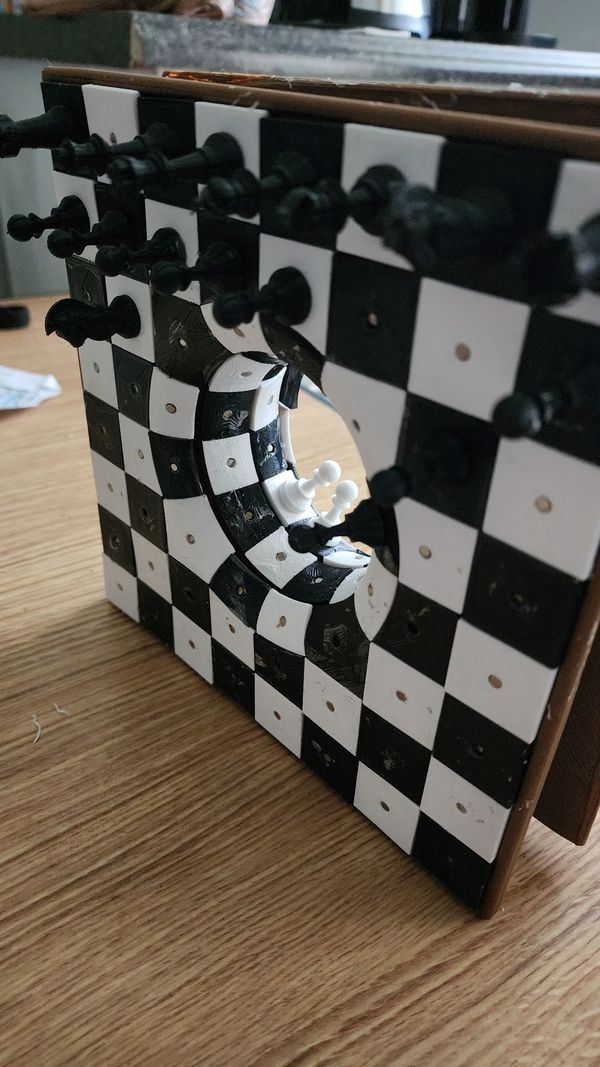 Photo of the 3d printed chessboard with a hole in the middle that leads to another chessboard