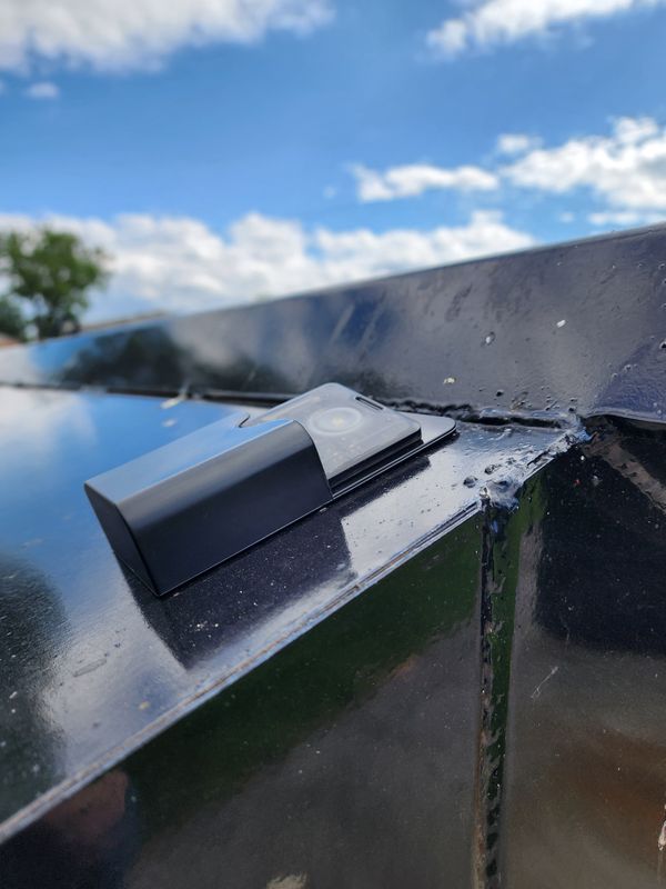 Photo of a T1000 meshtastic device in a magnetic pencil case attached to a dumpster